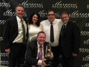 From the 2015 Radio Show: KS95’s Dave Bestler, Staci Matthews, Crisco, Dan Seeman and Moon (sitting) celebrate a 2015 NAB Marconi Award for Large Market Station of the Year.