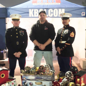 Nate Shelman poses for a photo with U.S. Marine Capt. Johnson and SSgt. Paala during a charity toy drive. (Courtesy photo)
