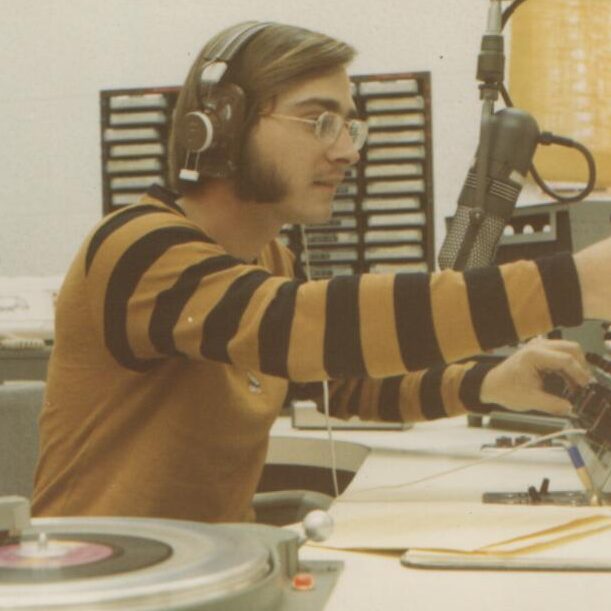 This is Bob May at his first job in college radio at KDLX-AM Maryville, MO. The year is 1971. Reach Bob at bob@kdkd.net.