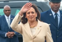 Vice President Kamala Harris waves after arriving at Ellington Field JRB.