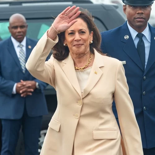 Vice President Kamala Harris waves after arriving at Ellington Field JRB.