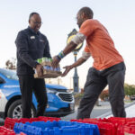 2-WGTS morning show host Jerry Woods helps load truck with volunteer-Eric