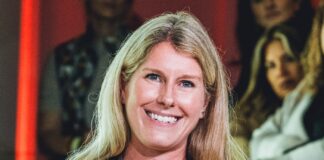 Lainie Fertick holding an iHeartMedia microphone while presenting