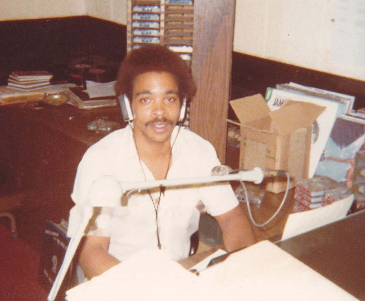 Ronnie Love at WJBE Ronnie Love seated at a microphone in the WJBE studio, wearing headphones